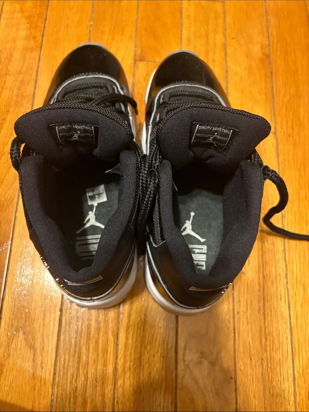 Air Jordan 11 Retro Black Patent and White-Trim High-Top Sneakers